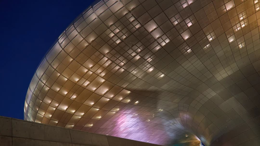 The curved metal exterior of Dongdaemun Design Plaza in Seoul, a shopping district landmark